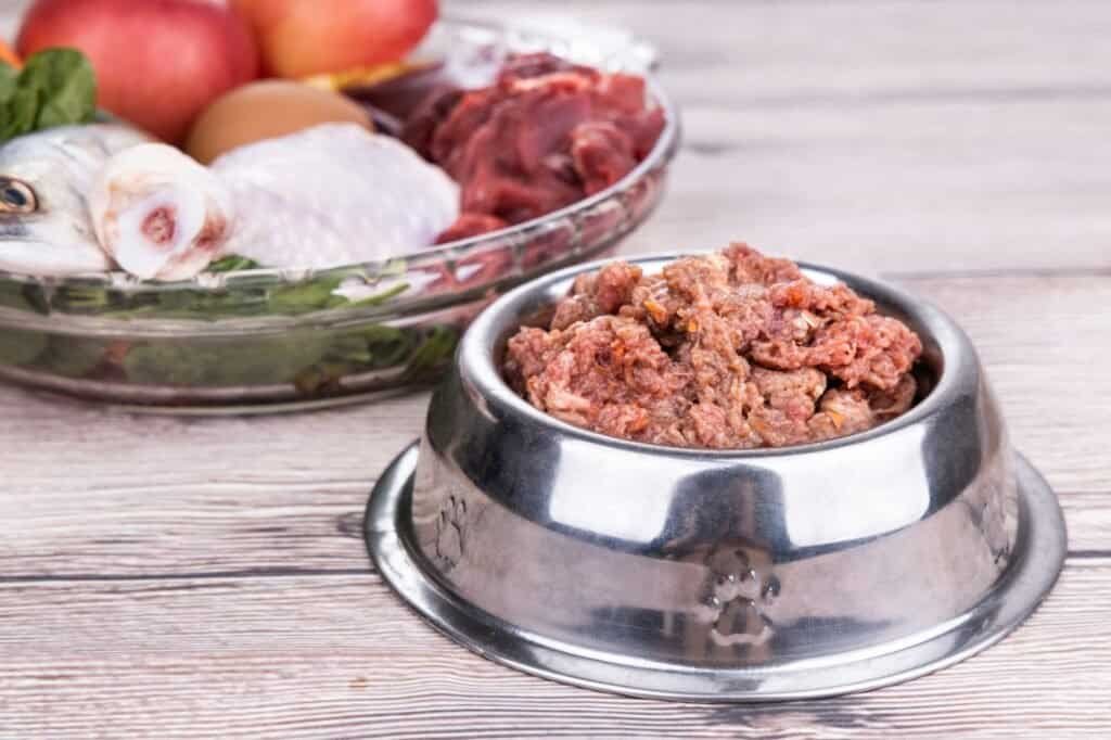 Minced barf raw food recipe ingredients for dogs consisting meat, organs, fish, eggs and vegetable